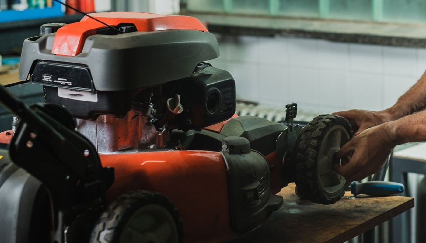 Image of a technician fixing a lawn mower